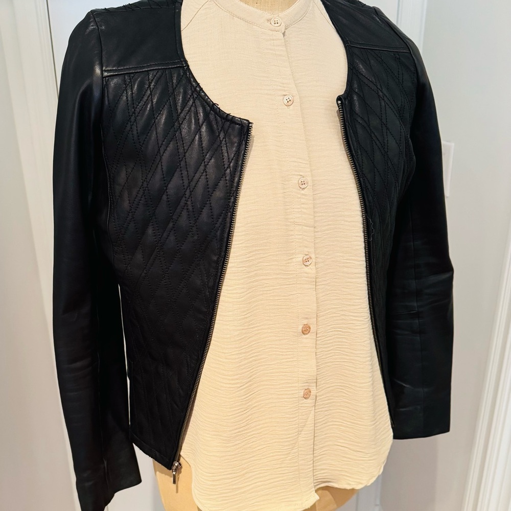 Black leather quilted jacket. Zips up great condition size medium.